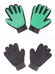 Close-up of pet massage gloves with green silicone bristles and black mesh fabric