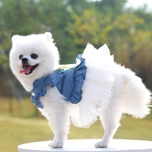 Detail of blue denim pet dress with white tutu mesh skirt and yellow ribbon bow