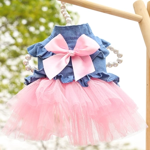 Close-up of denim pet dress with pink satin bow and layered mesh tutu skirt details