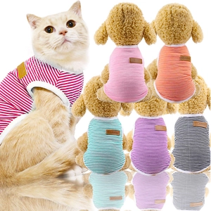 Detail of colorful striped cotton pet vests for cats and dogs with classic leather label
