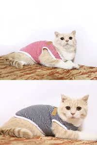 Detail of striped cotton dog and cat vests in red and black colors with white piping