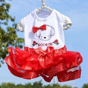 Detail of pet summer dress featuring cartoon dog print and red polka dot mesh tutu skirt