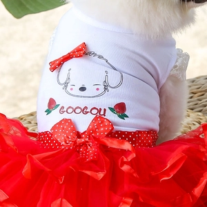 Detail of dog summer dress featuring red mesh tutu skirt and bow accents on white cotton