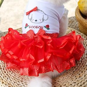 Detail of red tiered tulle pet dress with polka dot ribbons and cute strawberry pattern