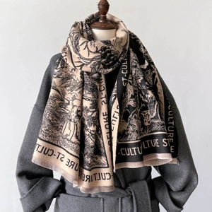 Macro shot of vintage landscape print and frayed fringe detail on thick beige scarf
