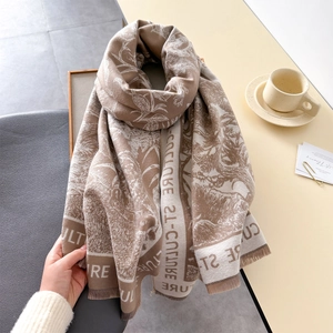 Detail of vintage knit shawl featuring fringe edges and culture letter jacquard pattern