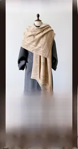 Detail of beige cashmere scarf with vintage carriage floral jacquard and tassel edges