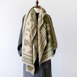 Vintage paisley pattern scarf in olive green and beige with fringe on mannequin