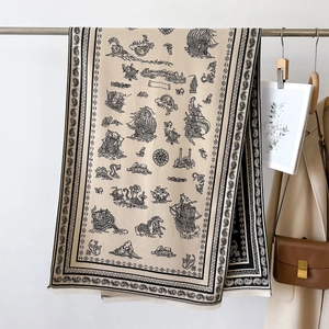 Detail of vintage beige scarf with black nautical print and tassels on a metal rack
