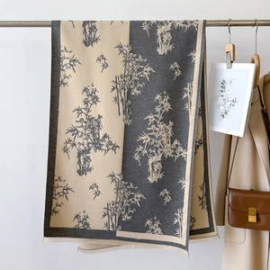 Detailed texture of thick cashmere shawl with bamboo print and tassel edge