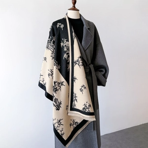 Detail of bamboo pattern print on beige cashmere-feel shawl with delicate tassel fringe
