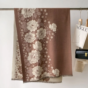 Detail of vintage floral jacquard shawl featuring refined tassels and premium texture