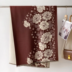 Close-up of floral jacquard shawl showing fringe details and soft wool texture
