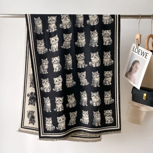 Close-up of cute cat jacquard pattern and tassel edges on thick cashmere-like scarf