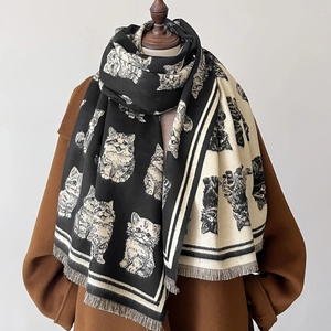 Cute cartoon cat pattern winter scarf with tassels for women worn on a brown coat