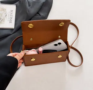 Top view of brown leather bag interior showing capacity for phone and cosmetics
