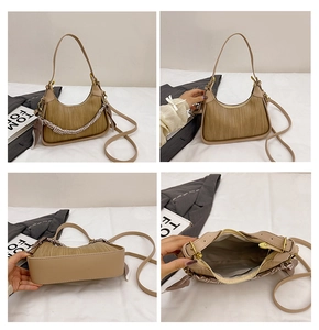 Detail view of brown textured hobo bag featuring silk scarf handle and internal pockets