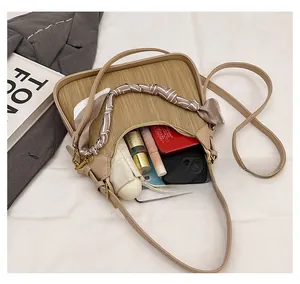 Detail view of khaki woven bag interior showing capacity for umbrella and cosmetics