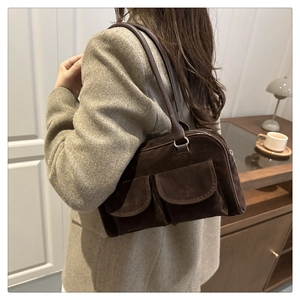 Detail of dark brown matte leather shoulder bag with double front flap pockets
