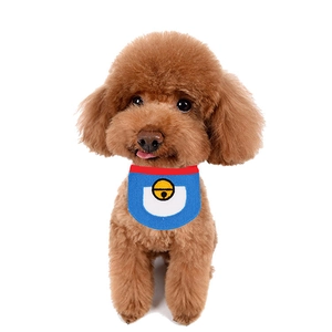 Close-up of blue and white pet bandana with bell pattern on a brown poodle