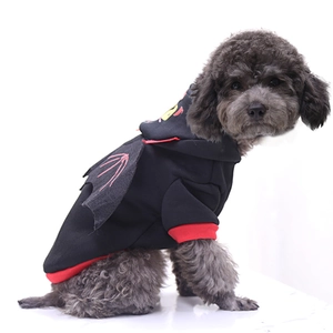Detail of pet Halloween hoodie featuring black bat wings and monster embroidery on hood