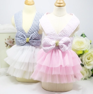 Detail of striped pet tutu dress with mesh skirt and decorative bow with pearl button
