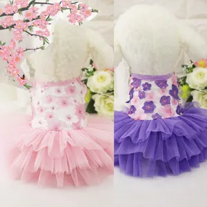 Detail of pink and purple tiered mesh pet dresses with floral embroidery accents