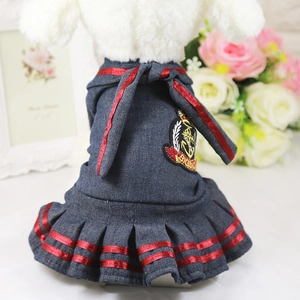 Detail of nautical pet dress featuring navy denim fabric and a red silk ribbon bow