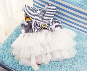 Detail of blue striped pet dress featuring layered mesh skirt and bow with gold bead