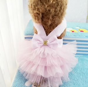 Close-up of pink layered mesh pet dress featuring a checkered bow and gold bead detail