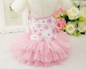 Detail of pink floral pet dress with tiered tulle skirt on a white plush model