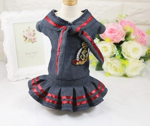 Detail of navy style denim pet dress with anchor embroidery and red striped trim