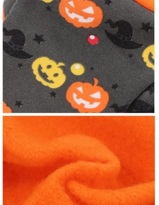 Detail of Halloween pet costume showing black printed fabric and soft orange fleece lining