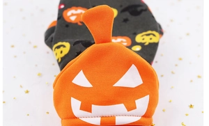 Detailed view of pumpkin-themed Halloween pet costume with soft knit fabric and cute hat