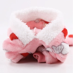 Detail of pink flannel pet vest with white fleece collar and red heart patterns