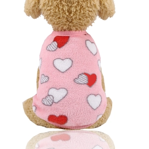 Close-up of pink flannel pet vest with heart patterns for small dogs winter warmth