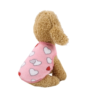 Close-up of pink flannel pet vest with red and white heart patterns and soft fleece texture
