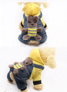 Detail of yellow pet hoodie with denim overalls and a small brown plush bear