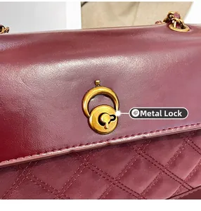 Macro shot of the vintage gold twist lock and diamond quilted leather on the handbag