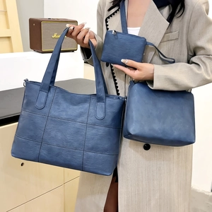 Three-piece blue PU leather tote bag set with quilted grid stitching shown in home setting