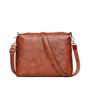 Brown vintage textured leather shoulder bag with adjustable strap and silver metal hooks