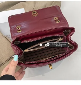 Detailed interior of quilted crossbody bag with multiple compartments and striped lining