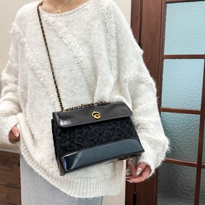 Maillard vintage black quilted chain bag with leopard print and gold hardware worn by a model