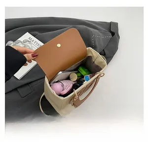 Top view of spacious interior in beige canvas and brown leather crossbody bag