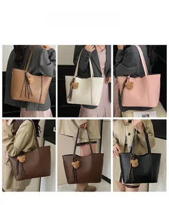 Detailed view of large tote bags in multiple colors with bear charms and fringe