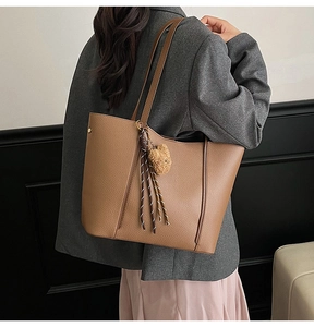 Brown tote bag in textured faux leather with cute bear charm and woven side detail