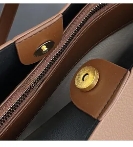 Detailed macro of golden magnetic snap button and zipper closure on tote bag