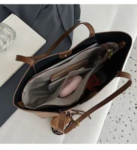 Detail view of large brown tote bag interior with multiple storage compartments