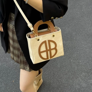Chic beige canvas and brown leather crossbody bag with HB logo for women
