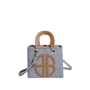 Chic gray felt small tote bag with brown leather handles and adjustable shoulder strap